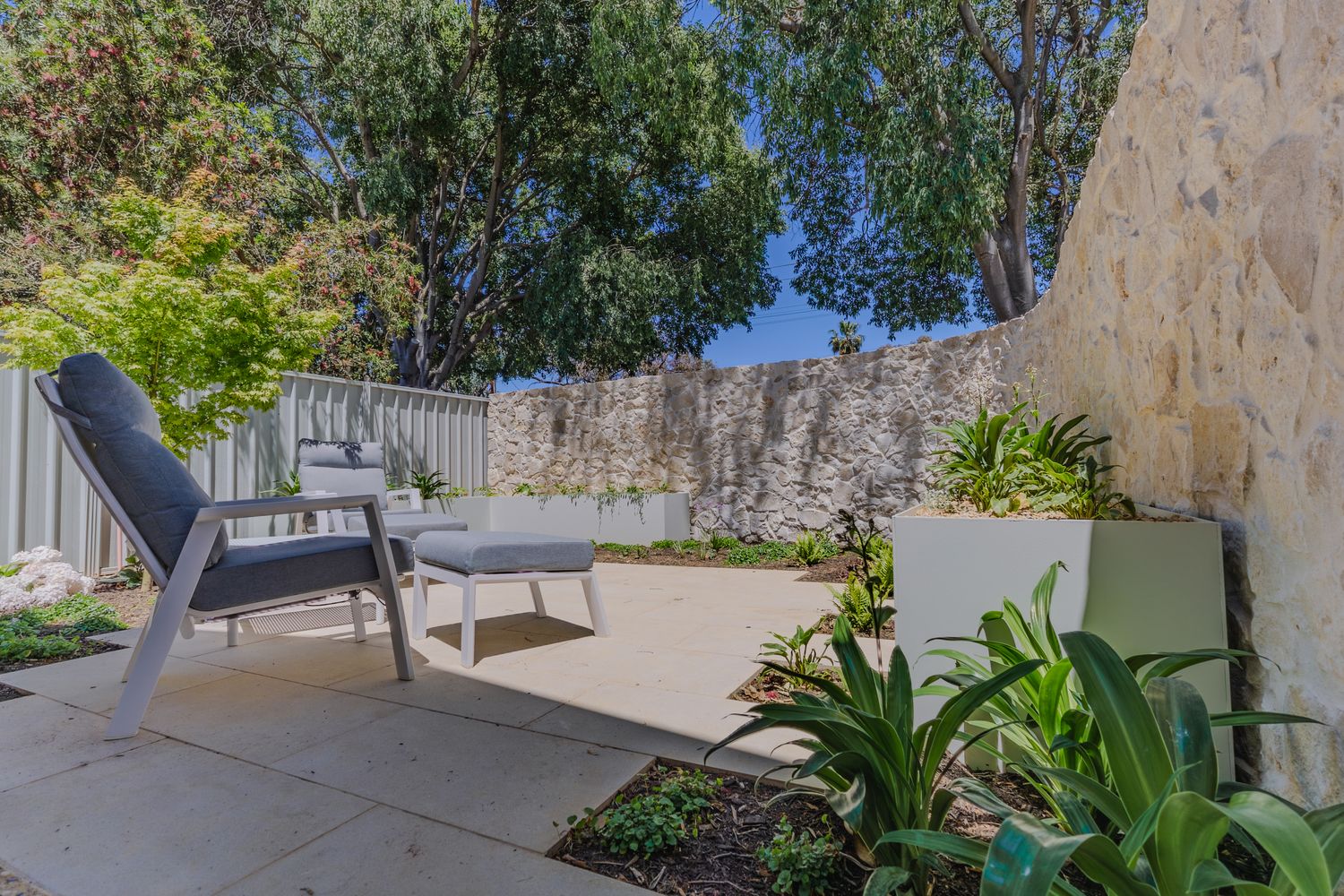 Limestone retaining wall and poolside terrace